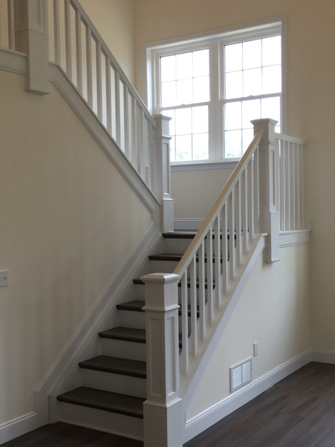 Split stairs with oak-treads and painted risers with a large window at the landing