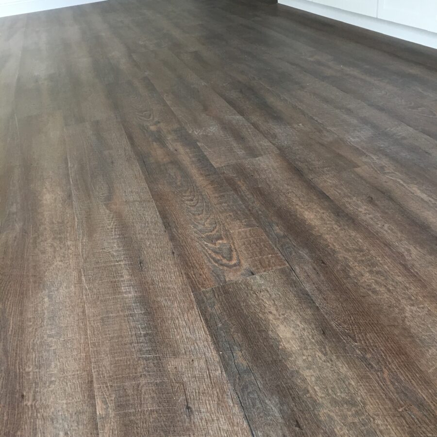 A close-up of the Luxury Vinyl Plank flooring throughout the entire house.