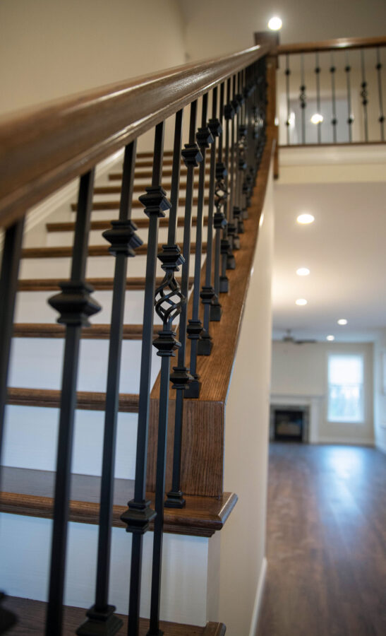 Oak Tread, Painted Riser, Open Mitre & Box Set Combination Stairs with an Iron Railing.