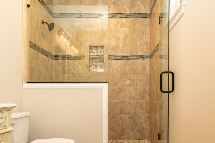 A custom-tiled shower with a glass door