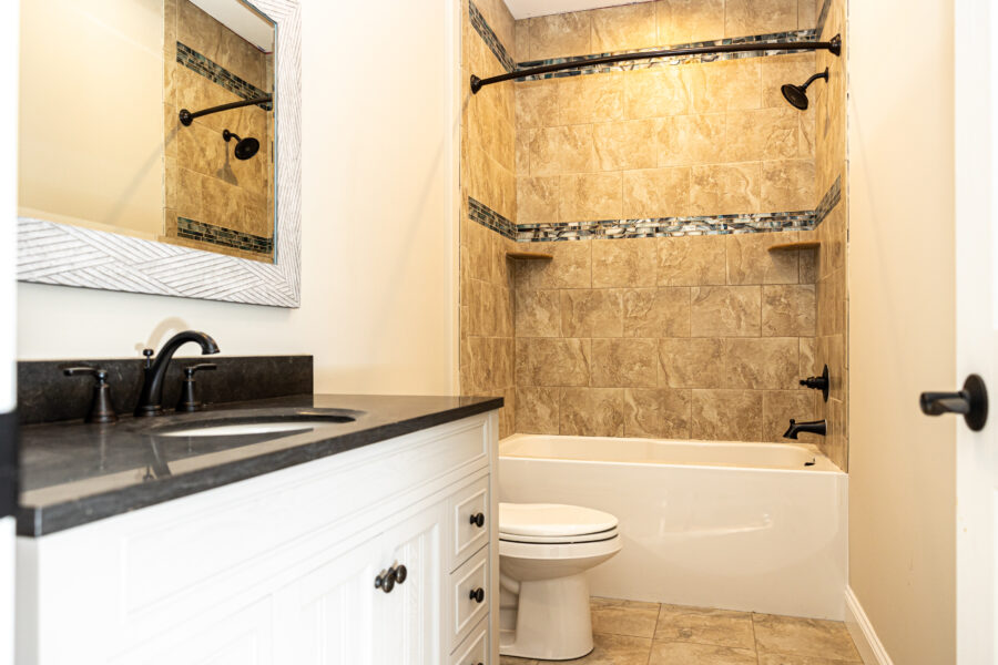 The bathroom with a custom-tiled shower
