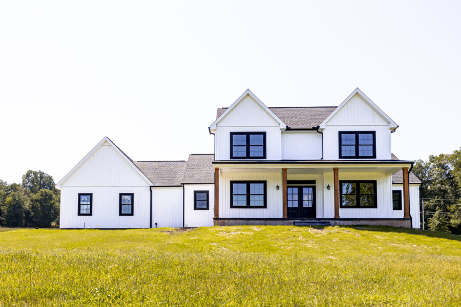 The exterior to a white custom-built modern farmhouse