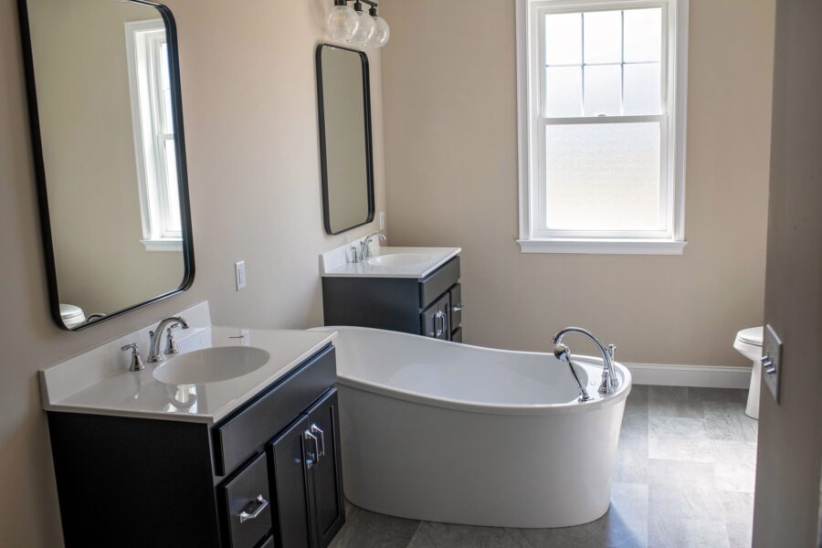 The master bathroom with 2 vanities and a soaking tub