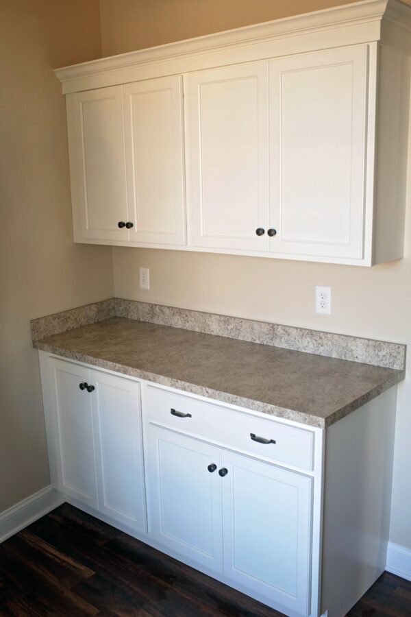 Counter space and cabinet storage in the laundry room
